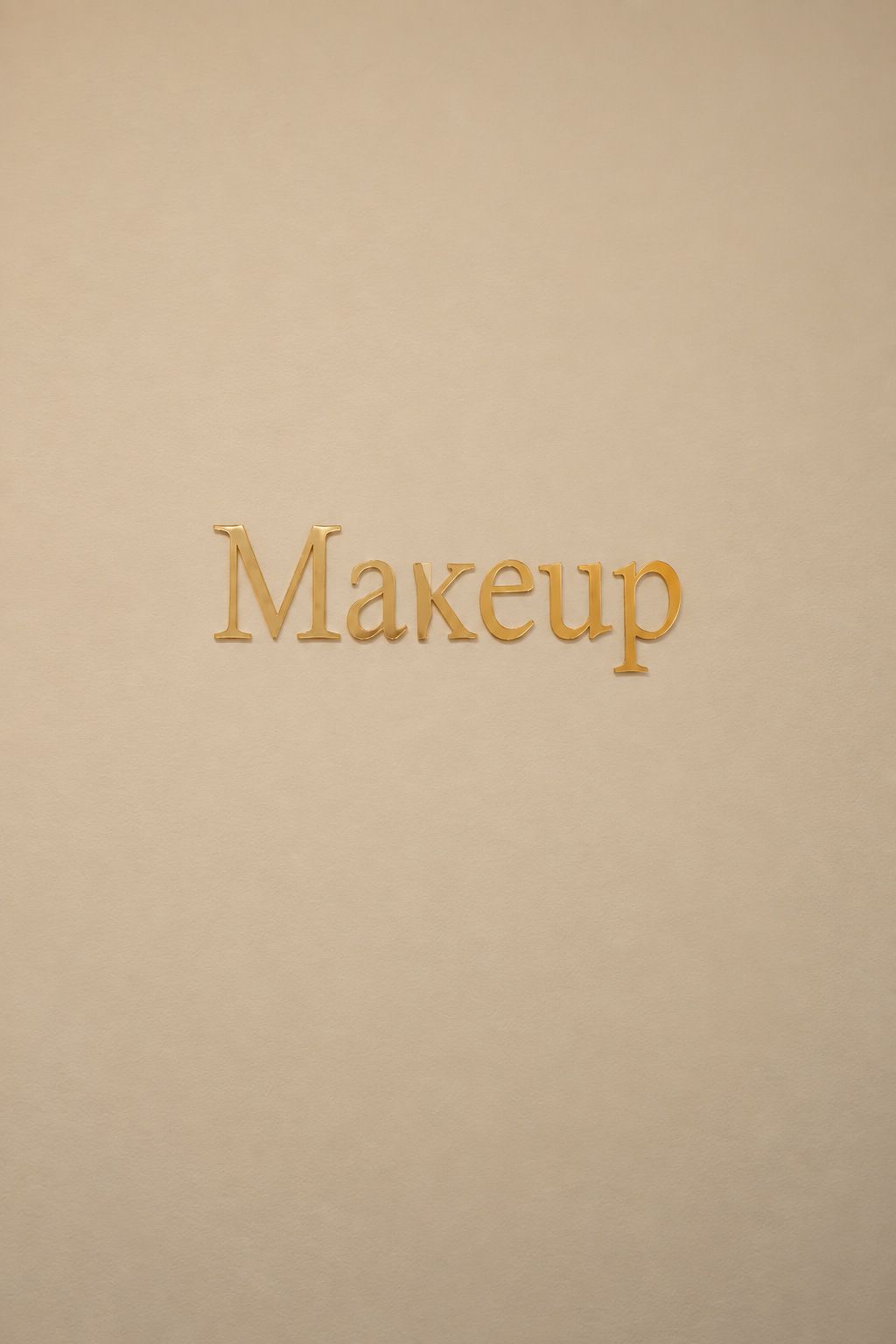 Gold Makeup lettering on a cream salon wall