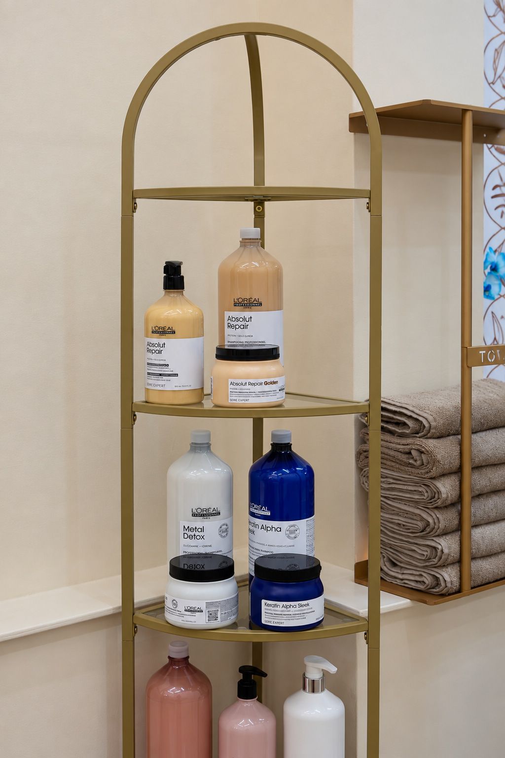 Professional haircare products on an arched gold shelf