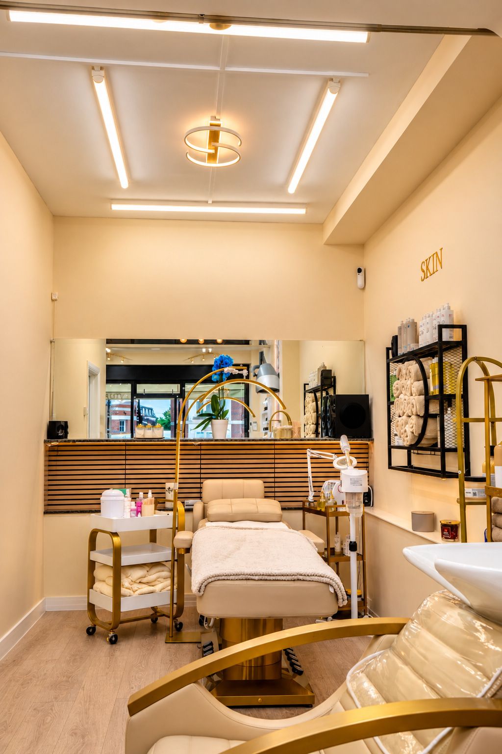 A corridor leading to the calm treatment room, with a gold towel shelf